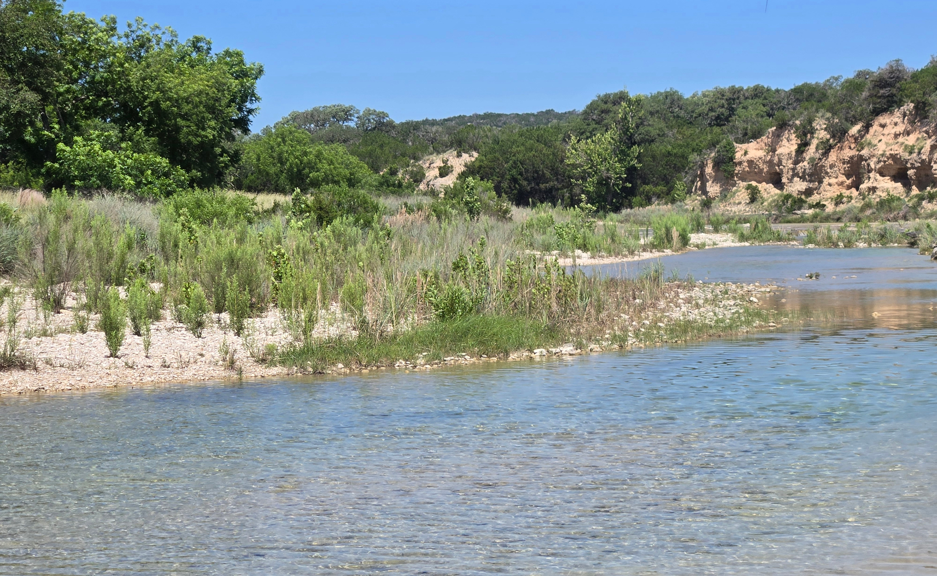 Clear Hill Country river with limestone banks and cedar bluffs